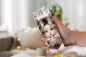 Preview: Auf dem Bild ist ein Thermobecher, auf dem ein Mädchen mit großen Augen zu sehen ist, das einen Becher hält, auf dem 'coffee' steht, ergänzt durch den Schriftzug 'All I Need is coffee'.