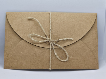 Hochwertiger Umschlag aus Kraftpapier mit Herzverschluss für die moderne Weihnachts-Rubbelkarte.