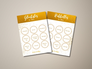 Preview: Personalisierte Rubbellos-Karte mit Namen – Glückslos mit 9 Rubbelfeldern als Geschenkidee Preview: Zwei freigerubbelte Rubbelkarten mit dem Namen „Tobias“ im gold-weißen Design. Jede Karte enthält neun Felder mit Begriffen wie „Massage“, „Kinoabend“, „Wellness-Tag“ oder „Frühstück im Bett“. Auf der rechten Karte erscheint „Massage“ dreimal als Gewinn.