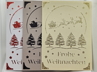 Handgefertigte Weihnachtskarten in drei Varianten: Weiß mit rotem Glitzer, Beige mit goldenem Glitzer und Grau mit schwarzem Glitzer. Karten zeigen filigranes Design mit Weihnachtsbäumen, Sternen und dem Schlitten des Weihnachtsmanns.