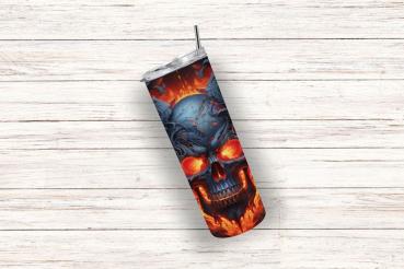 Ein einzelner Thermobecher mit feurigem Totenkopf-Design in leuchtendem Blau und Rot, schräg auf einem hellen Holz-Hintergrund positioniert. Der Becher verfügt über einen silbernen Deckel und einen Edelstahlstrohhalm und zeigt ein intensives, flammendes M
