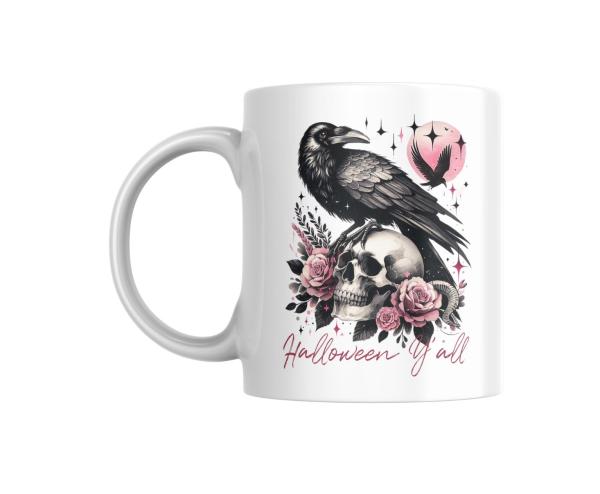 Weiße Tasse mit einem Halloween-Design: Ein detailreich gezeichneter schwarzer Rabe sitzt auf einem Totenkopf, der von rosafarbenen Rosen und Blättern umgeben ist. Im Hintergrund ist ein rosa Mond zu sehen, vor dem ein fliegender Rabe erscheint. Der Schri