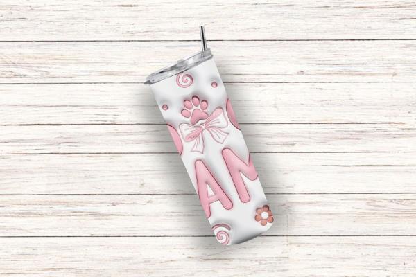 Schräg liegender weißer Thermobecher mit der Aufschrift 'DOG MAMA' in rosa Buchstaben. Der Becher zeigt eine Pfotenabdruck-Grafik mit Schleife, umgeben von Spiralmustern und Blumen. Perfektes Geschenk für Hundeliebhaberinnen.