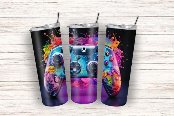 Thermobecher mit lebendigem Gaming-Controller-Design auf schwarzem Hintergrund, umgeben von spritzenden Farben in leuchtenden Tönen. Ein ausdrucksstarkes Motiv, das die Energie und Kreativität der Gaming-Welt einfängt.